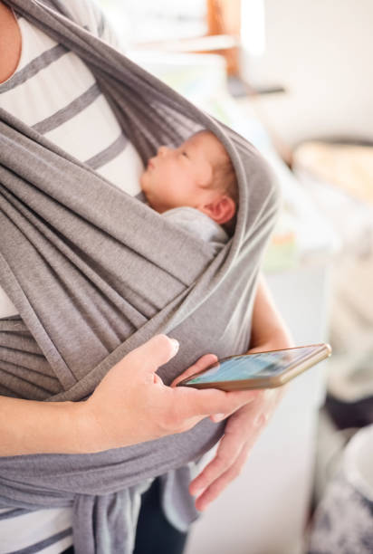 istock Newborn baby in a sling 1225775051