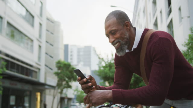 African American man using his phone in the street