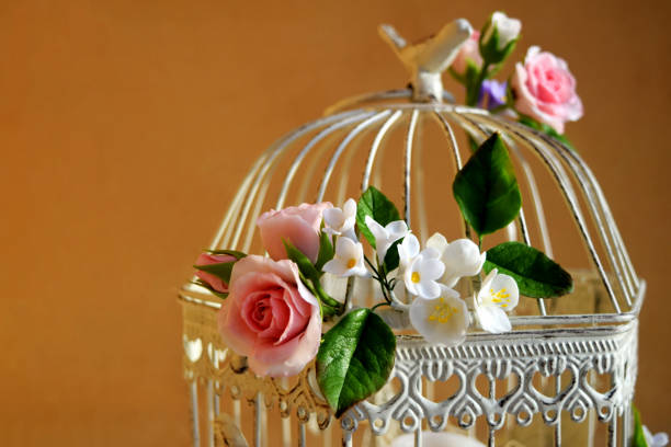 istock Bird cage with spring blossom flowers. Wedding decorations. 1225777388
