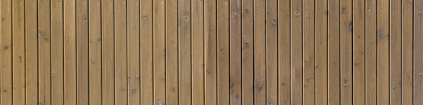 Wooden fence surface, wooden texture of a panoramic view. Texture of rustic wood planks aged.