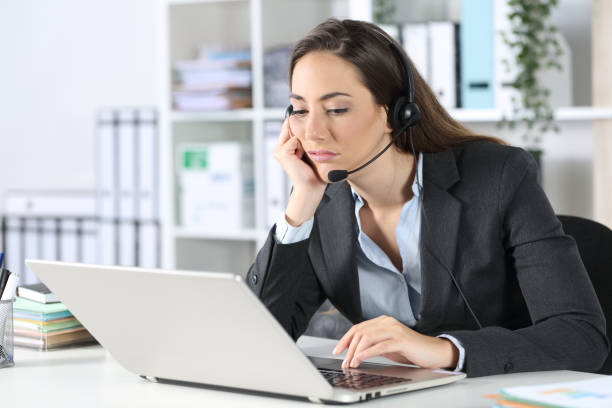 istock Bored telemarketer with laptop sitting at office 1225781231