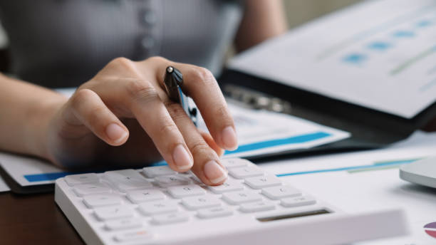 istock Close up accountant banker or bookkeeper making calculations with calculator 1225781323