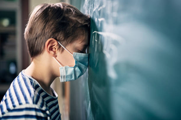 little boy depressed by school during covid-19 pandemic. - defeat imagens e fotografias de stock