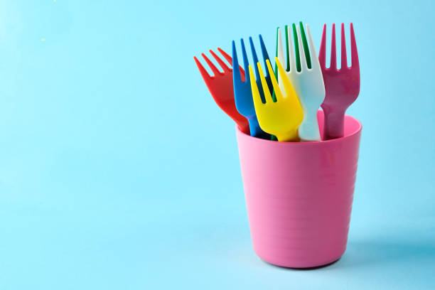 istock Multicolored plastic dishes on a blue background. The concept of environmental pollution by plastic, ecolog place for text, flat lay 1225786310