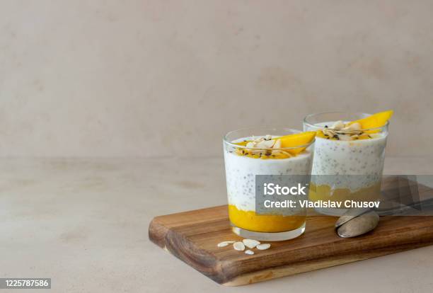 Yogurt In A Glass With Mango Chia And Almonds Healthy Eating Vegetarian Food Recipe Breakfast Diet Stock Photo - Download Image Now