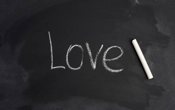 istock black chalk board and the inscription white chalk love 1225787921