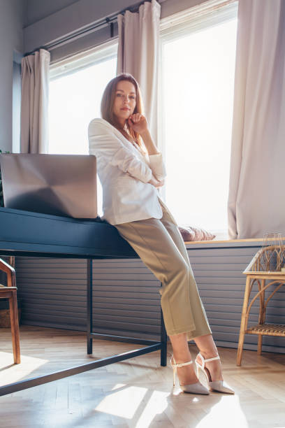 istock Young woman in office stands at workplace. 1225788632