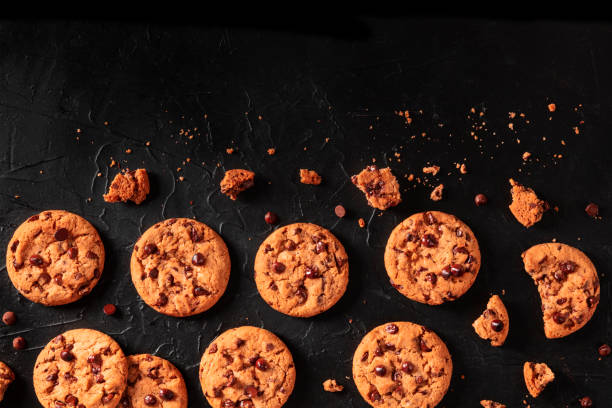 Chocolate chip cookies on a dark background, shot from above with copy space