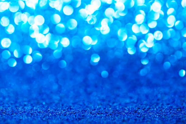 istock Blue glitter foil background. Shiny metal blue foil texture abstract defocused background. Sparkle glitter texture with bokeh lights 1225790005