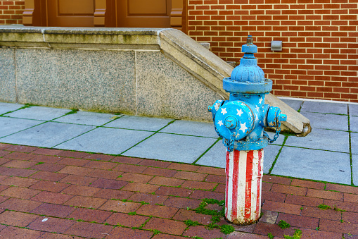 Harrisburg, PA / USA - May 15, 2020: A patriotic painted fire hydrant along a street in the downtown part of the city.