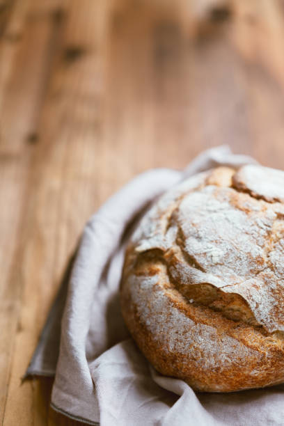 istock Home made freshly baked bread on wooden table 1225790459