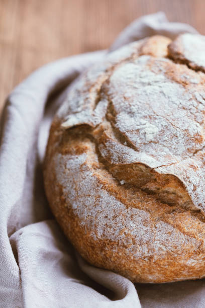 istock Home made freshly baked bread on wooden table 1225790480