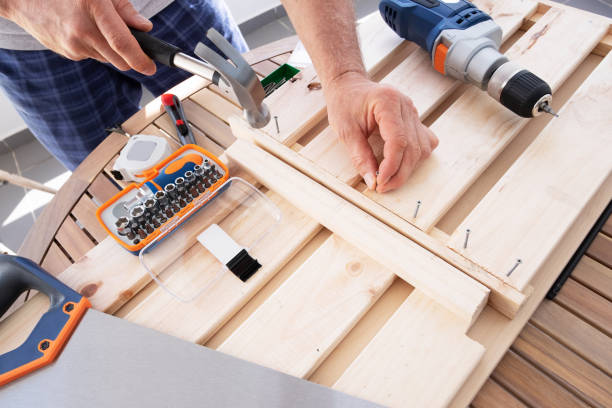 istock Hands driving nail with hammer into wooden shelf 1225792140