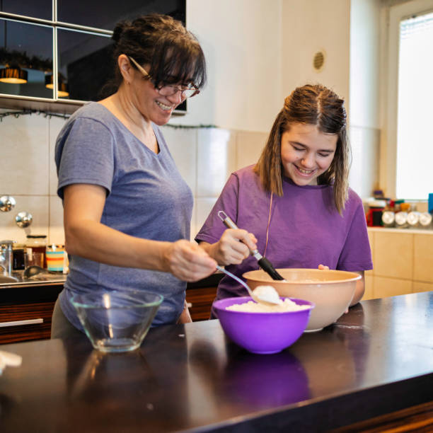 istock Little child makes pancakes with her mum's help 1225795609
