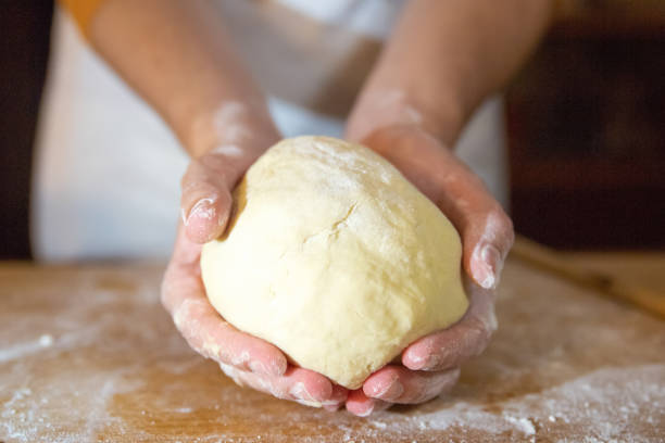 istock Unrecognizable baker holding kneaded dough in palms 1225795944