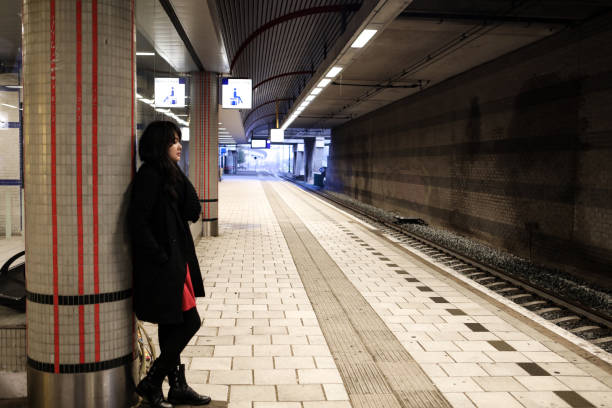istock Young woman  while waiting for subway in platform 1225796103