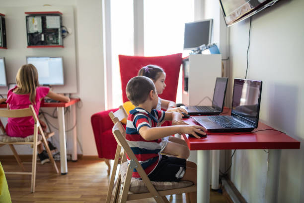 istock Preschool boy and girl using laptops in private IT school 1225796820