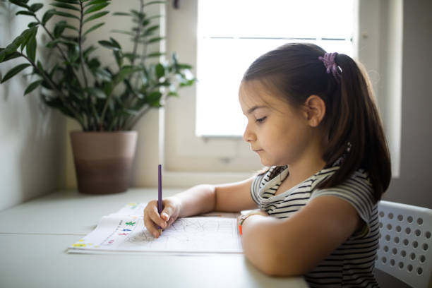 istock Girl doing homework in daycare 1225796826