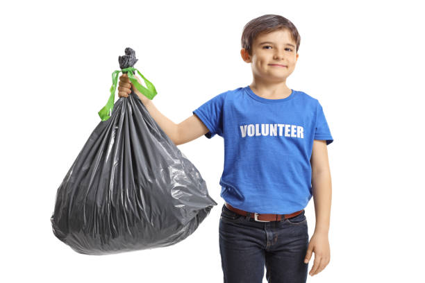 istock Boy volunteer holding a waste bag 1225799179