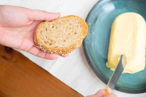 istock Woman cutting butter for slice 1225799513