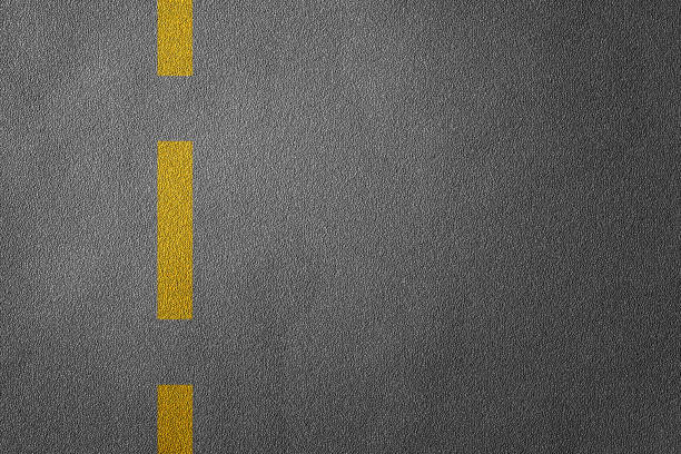 istock 3D Illustration of a road divide with yellow lines pattern and background, textured traffic rules concept. 1225800208