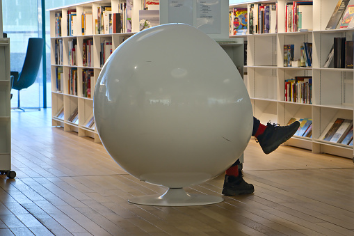 Helsinki, Finland – February 6, 2020: The ball chair provides a peaceful resting place. Oodi Libray is a popular meeting place in middle of city and has voted for world's best new library in 2019.