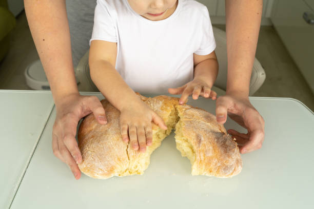istock dad and child are breaking baked bread 1225801083