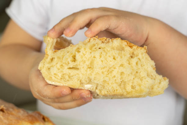 istock child holds a piece of fresh bread 1225801104