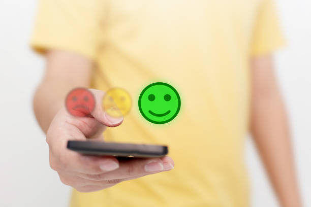 istock Customer Service Experience and Business Satisfaction Survey. Man choose face smile on smart phone 1225801888