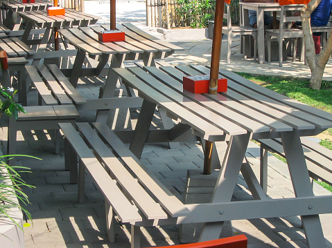 Close up shot of empty table and chairs in outdoor restaurant due to Covid 19 social distancing rule