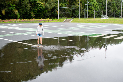 Girl playing in a puddle