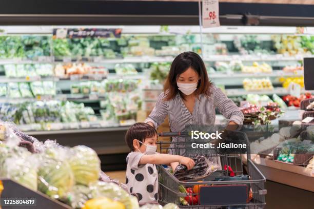 Mother And Son Wearing Face Masks Shopping Together In A Supermarket Stock Photo - Download Image Now