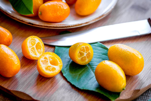 istock kumquat on plate at wooden table 1225806448