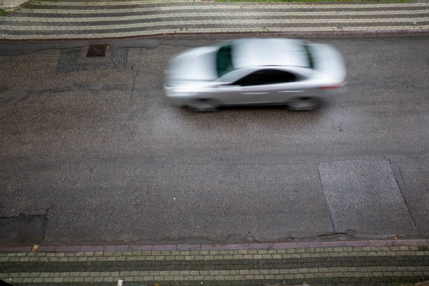 istock white car in street 1225806494