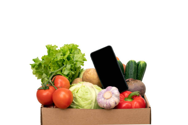 istock mobile phone near vegetables box. Delivery service from shop or restaurant concept. Quarantine, safe home delivery.Online market, green grocery delivery at home concept, buy online 1225808860