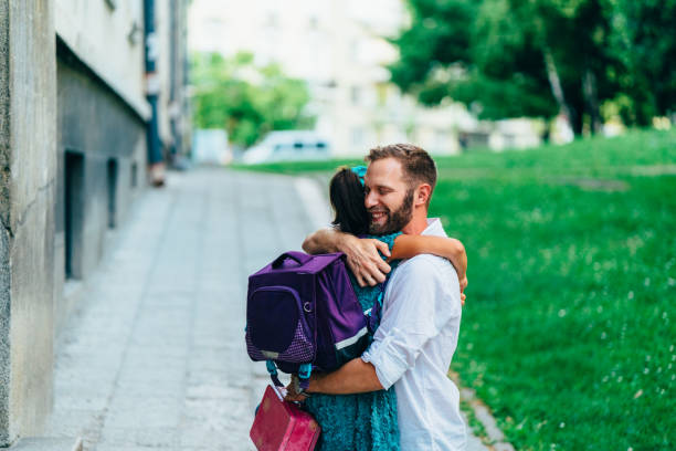 istock Little girl hugging her father before going to school 1225810531
