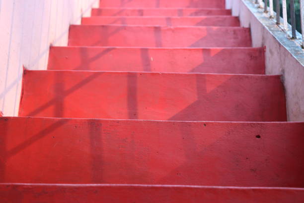istock Home stairs also called as steps which is red in color and sunlight falling on it 1225811557