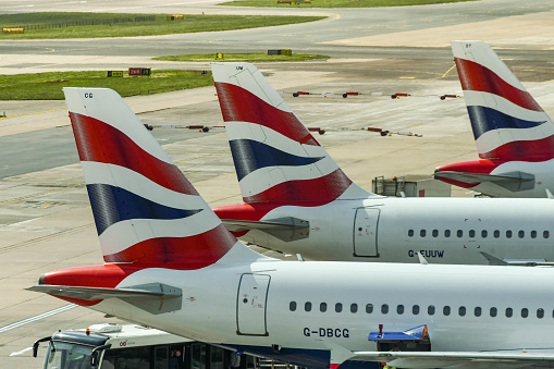 LONDON GATWICK AIRPORT, ENGLAND - APRIL 2019: Tail fins of three British Airways jets at Gatwick Airport