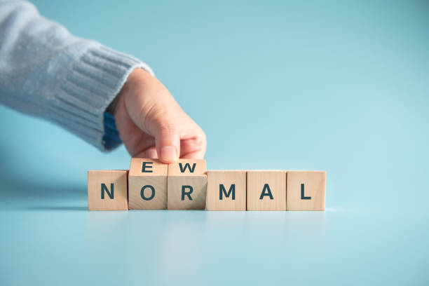 istock Hand flipping wooden cubes with NEW NORMAL word. 1225813749