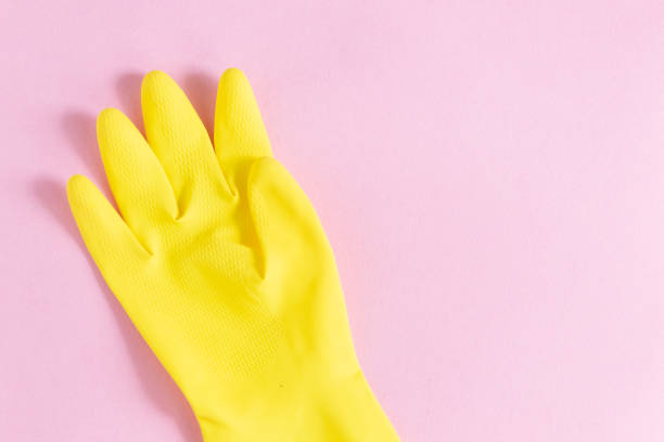 istock Protective yellow hand gloves isolated on pink background 1225816899