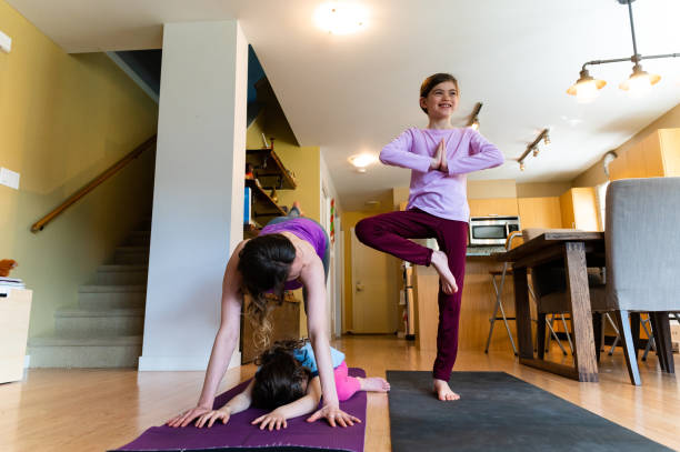 istock Mother and daughters doing home yoga during lockdown 1225818230