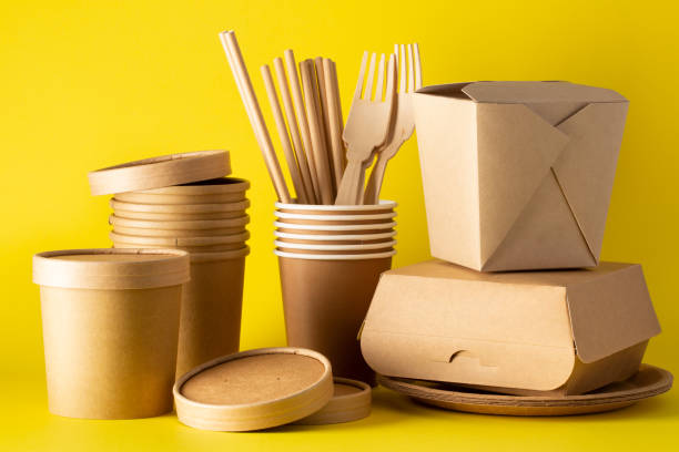 istock Eco friendly food containers from paper on yellow background.  Plastic free. Space for text. 1225818424