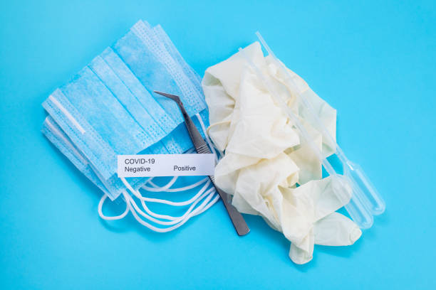 istock medical mask, plastic cups and other objects on yellow background 1225818426