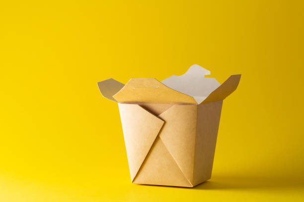 istock Eco friendly container for noodles from paper on yellow background. Plastic free. Space for text. 1225818429