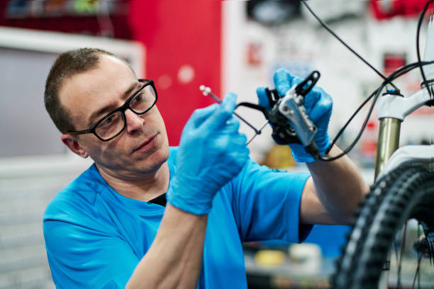 istock a man repairs a bike in his small business workshop 1225818575