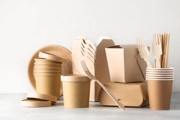 Eco friendly food containers from paper on light table. Plastic free. Space for text.