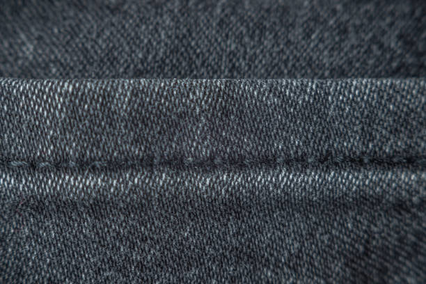 istock A seam on dark gray denim pants, close-up. Details textile, fabric, selective focus 1225818755