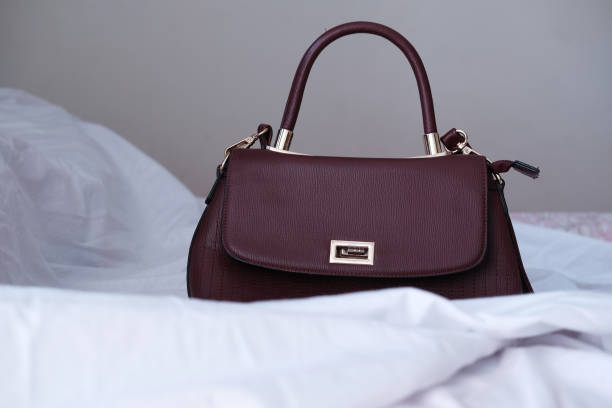 istock women purse wallet on bed, close up 1225819375