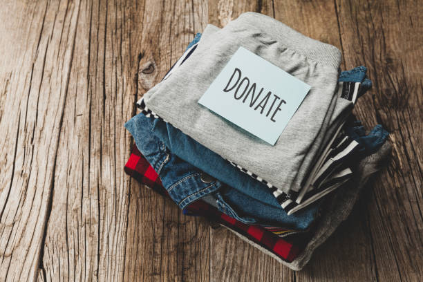 istock Stack of old clothes to discard (declutter) or donate. Recycling fabric cotton 1225820230