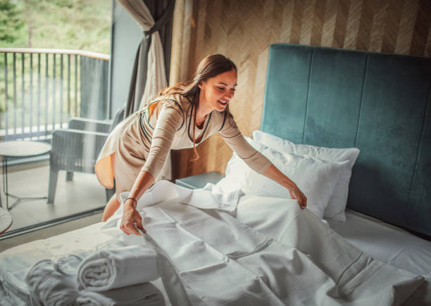 istock Housekeeper making the bed at a hotel 1225821180